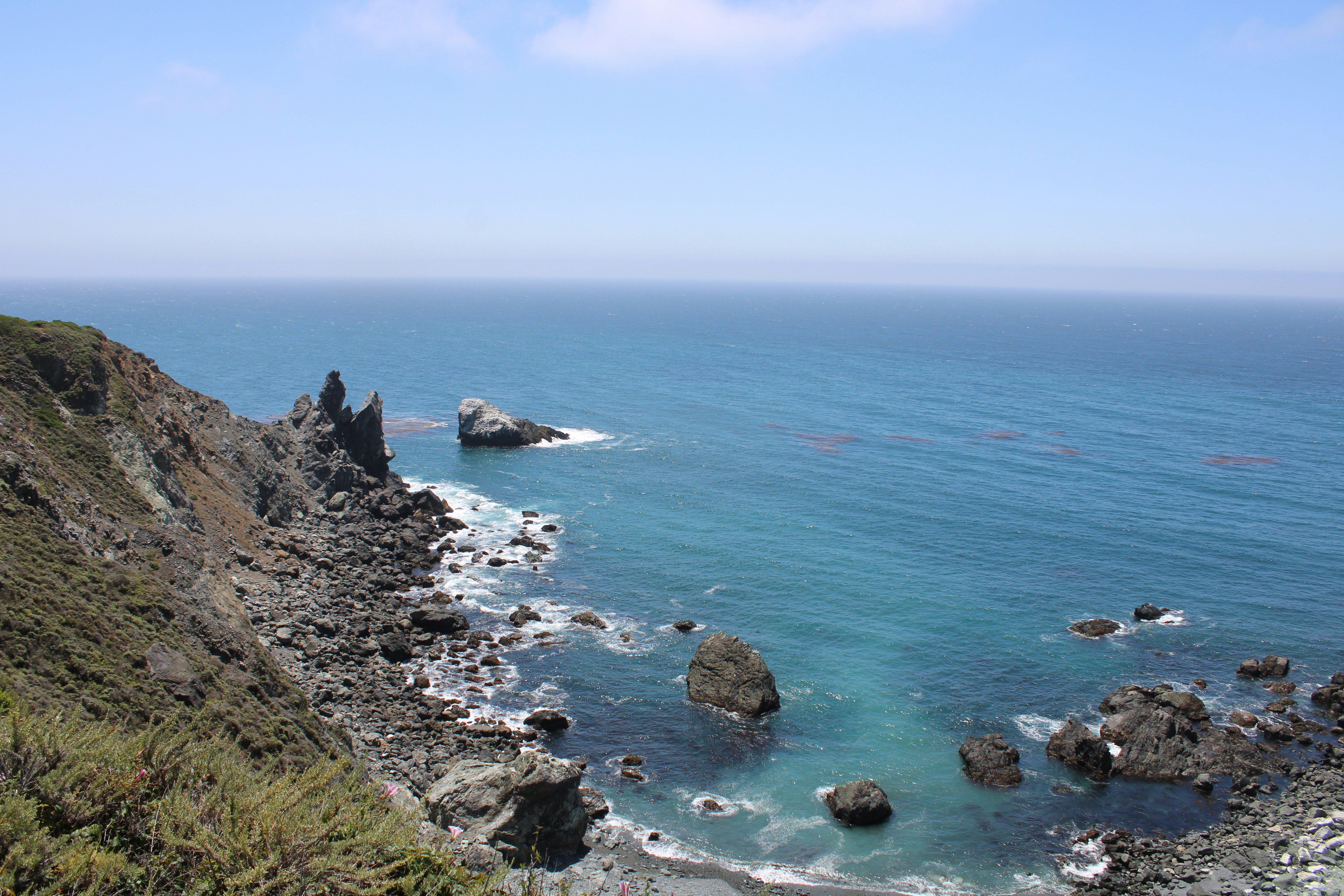 Rocky coastline beside blue ocean water
